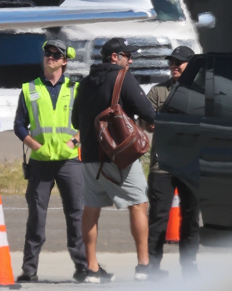 Glam Lady Gaga cradles her baby as she touches down in LA with fiancé Michael Polansky