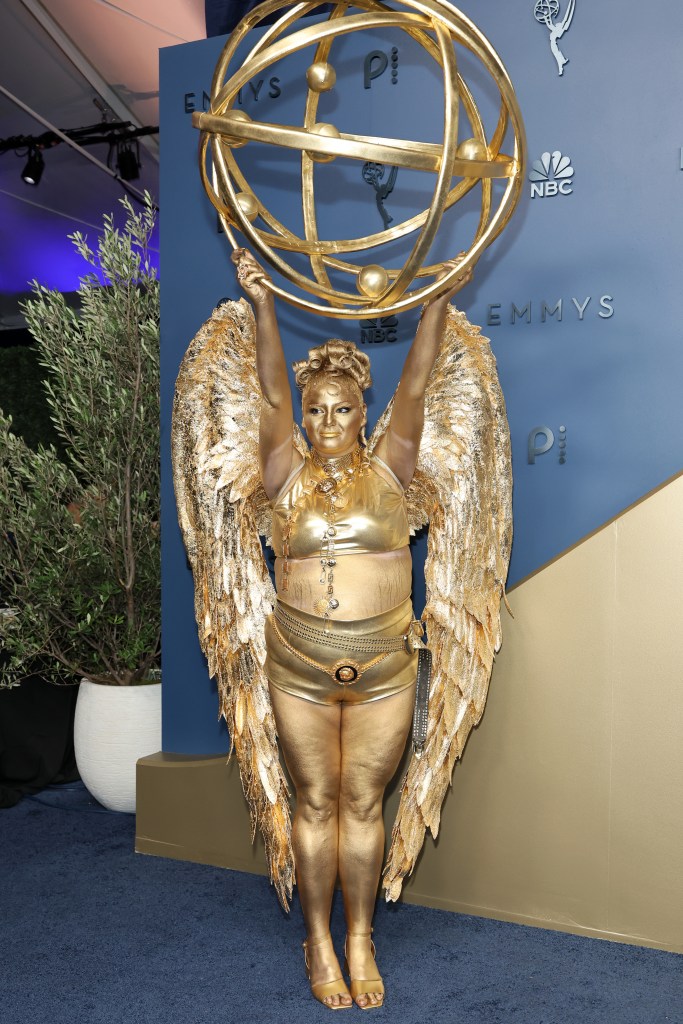 Meg Stalter is a life-sized Emmys 2026 statuette on the red carpet