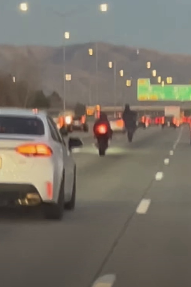 Instant karma for motorcyclist showing off on busy highway