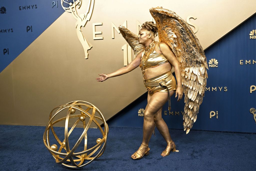 Meg Stalter is a life-sized Emmys 2026 statuette on the red carpet