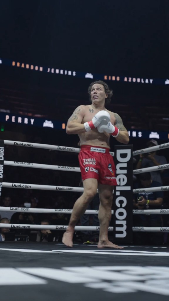 Kickboxer with SS tattoo gives Nazi salute after beating Jewish opponent — as supporters hold swastika banner