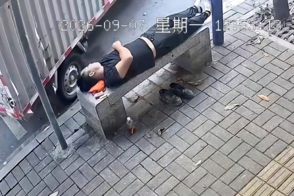 Oblivious napper escapes death as billboard torpedoes into bench inches from his head: video