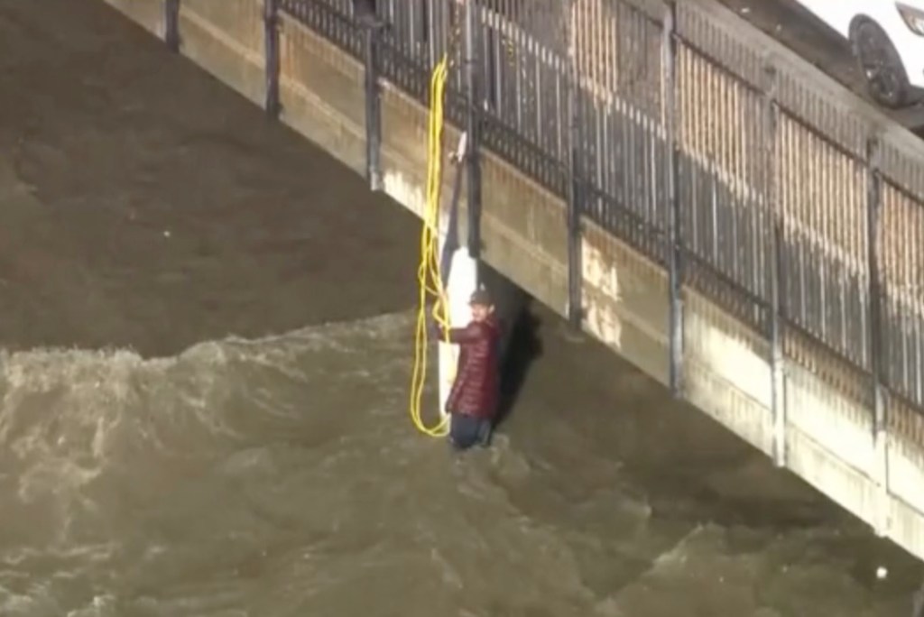 Raging floodwaters sweep several into overflowing LA channel, prompting dramatic rescue