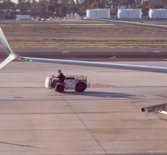 Wild moment unhinged man steals airport tow vehicle for joyride around tarmac at California airport — as maniac is unmasked