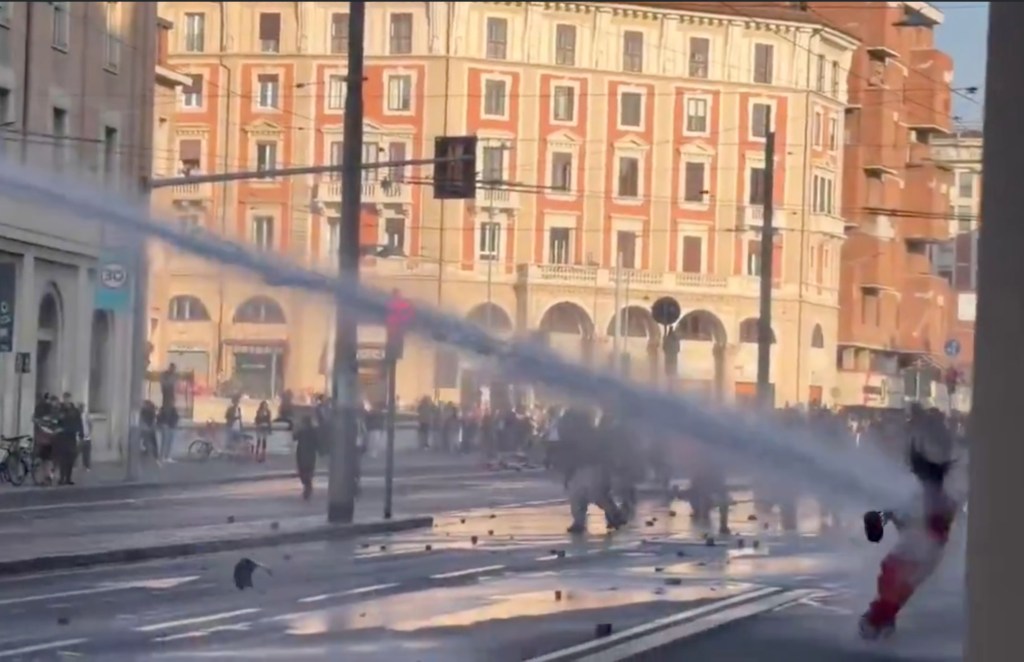 Wild moment Italian cops blast young protester with water cannon after she joined far-left rioters