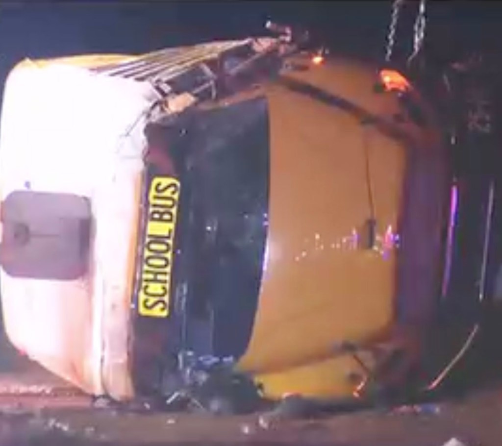 25 hurt when elderly driver of Ga. High school football bus loses control and flipps over