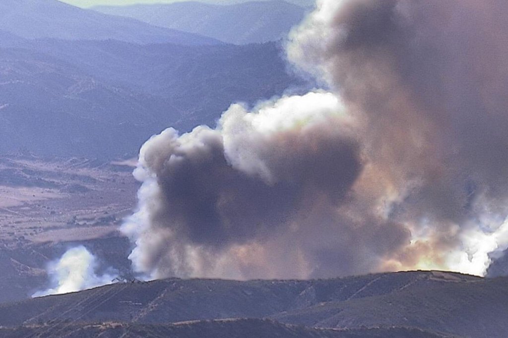 Fast-moving wildfire shuts down major California freeway as flames rage